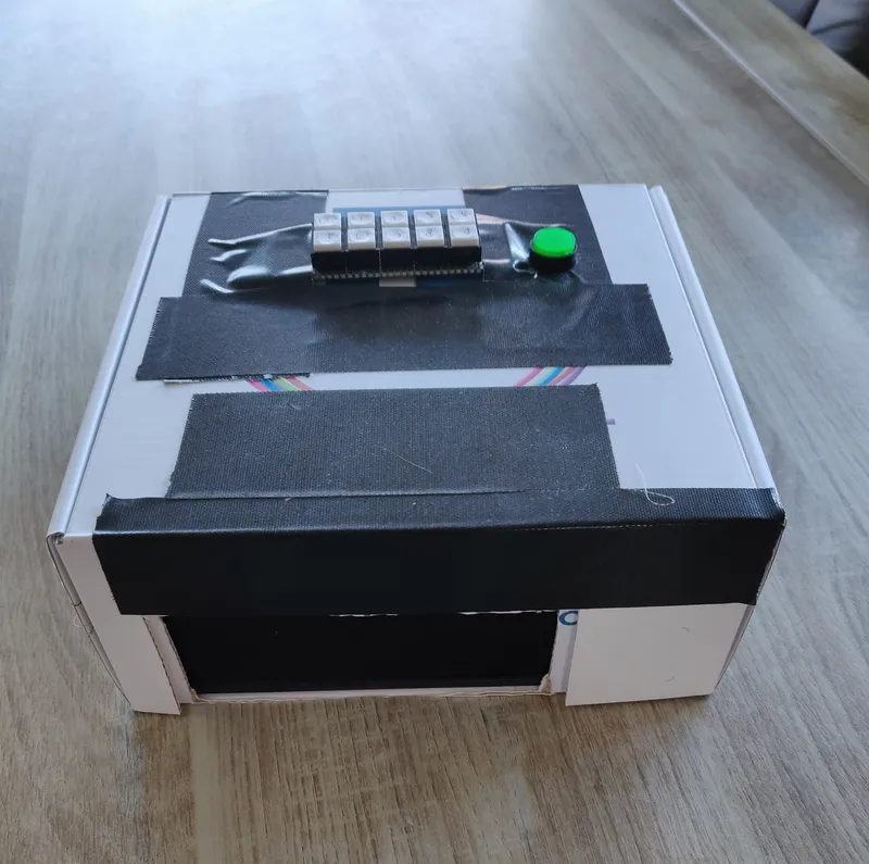 A prototype consisting of a cardboard box with buttons taped to it